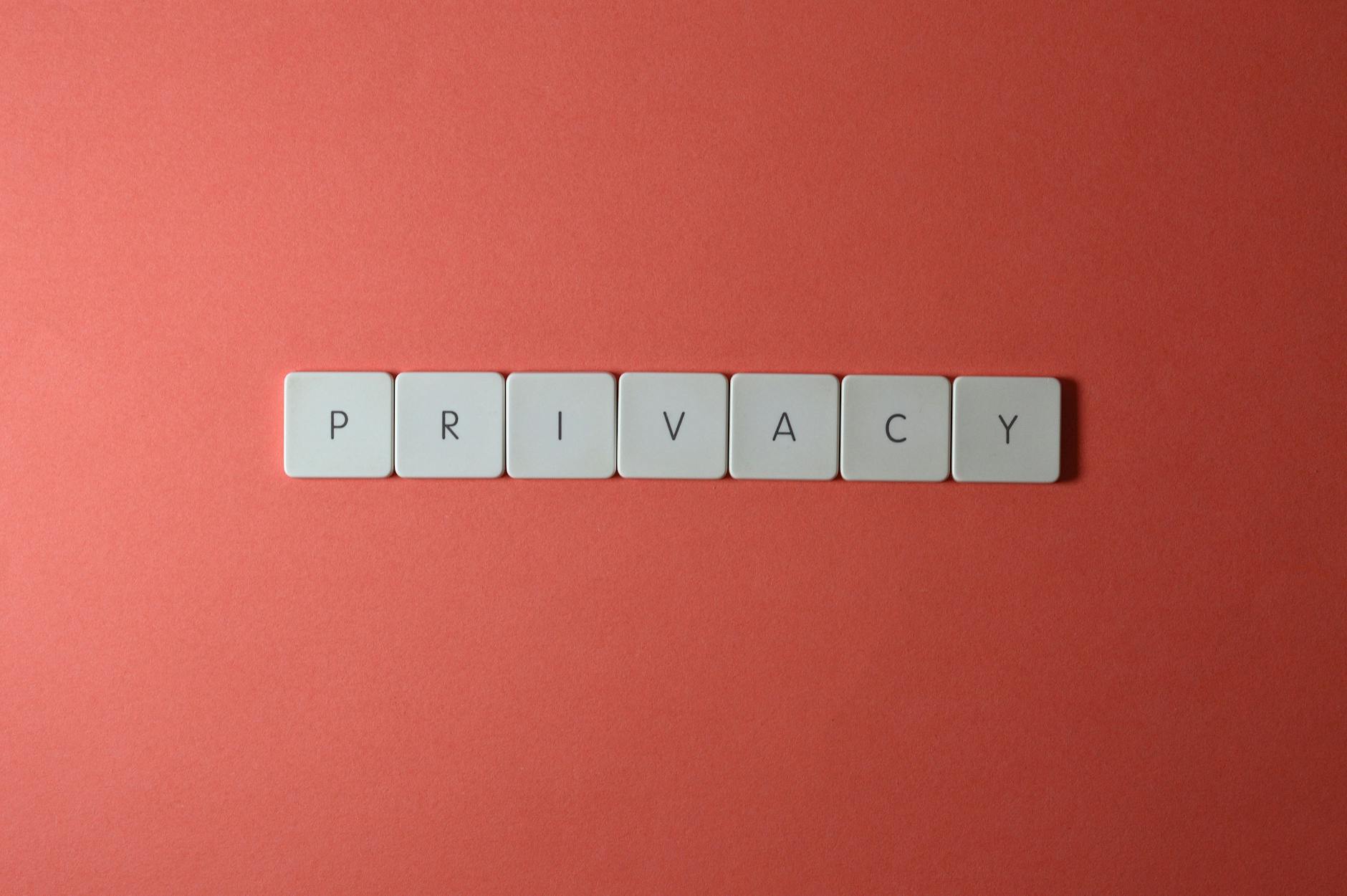 Close-up of letter tiles spelling PRIVACY on a red background, symbolizing data protection.